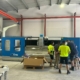 Operators training on a CMS Brembana Speed CNC machine on the factory floor